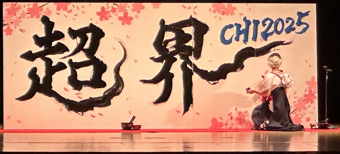 Opening ceremony at CHI 25 with woman in traditional dress painting on a surface.